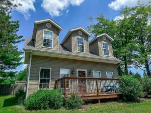 a house with a porch with a roof at New: Charming and Cozy Great Value in Swanton