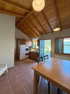 a kitchen and dining room with a wooden table at Apollon Heritage House in Palaiókipos