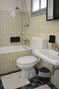a bathroom with a white toilet and a sink at Lavanda Cozy Apartment near Lake Como and Lugano in Lanzo dʼIntelvi