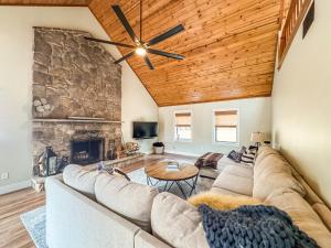 a living room with a couch and a stone fireplace at Modern Stunning Private Flat Lakefront in Oakland