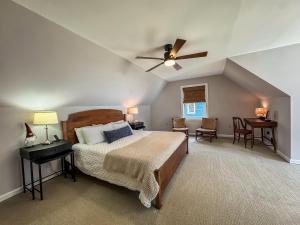 a bedroom with a bed and a ceiling fan at Modern Stunning Private Flat Lakefront in Oakland