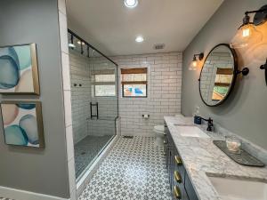 a bathroom with two sinks and a shower at Modern Stunning Private Flat Lakefront in Oakland +33 photos