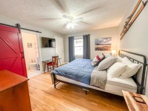 a bedroom with a bed and a ceiling fan at Lakefront Dock Fire Pit Hot Tub Value in Swanton