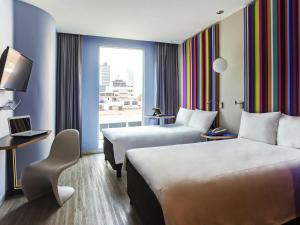 a hotel room with two beds and a window at Ibis Styles Mexico Reforma in Mexico City +34 photos