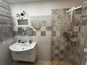 a bathroom with a sink and a shower with a tv at Boffi house in Sezze
