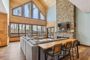 a living room with a couch and a table at Lakefront Private Indoor Pool New in Mountain Lake Park