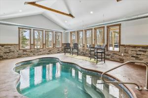an indoor swimming pool in a room with windows at Lakefront Private Indoor Pool New in Mountain Lake Park