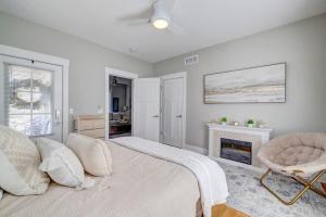 a white bedroom with a bed and a fireplace at 25 OFF 1 Mile to IU Walk to Town in Bloomington