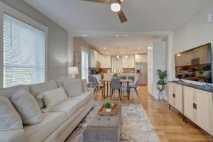 a living room with a white couch and a kitchen at 25 OFF 1 Mile to IU Walk to Town in Bloomington