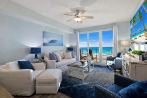 a living room with a couch and a table at Amazing Sunsets Steps to Pier Park Heated Pool Hot Tub in Panama City Beach