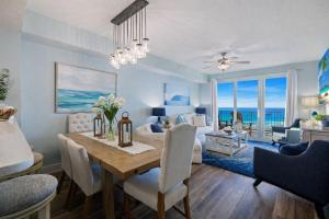 a dining room and living room with a table and chairs at Amazing Sunsets Steps to Pier Park Heated Pool Hot Tub in Panama City Beach
