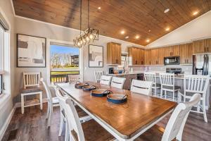 a kitchen and dining room with a wooden table and chairs at THE VIEW Hot Tub Fire Pit Private in McHenry