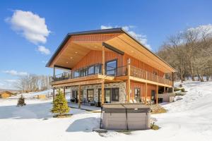 a large wooden house in the snow at THE VIEW Hot Tub Fire Pit Private in McHenry