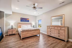 a bedroom with a bed and a dresser and a mirror at THE VIEW Hot Tub Fire Pit Private in McHenry