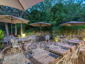 a group of tables and chairs with umbrellas at ibis Brignoles Provence Verte in Brignoles