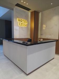 a hotel lobby with a hotel sign on the wall at Hotel Leon in Debar