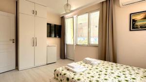 a small bedroom with a bed and a window at Hedi Sozopol in Sozopol