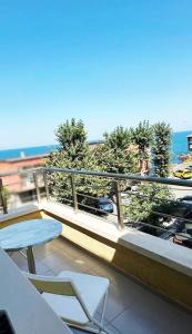 a balcony with a table and chairs and the ocean at Hedi Sozopol in Sozopol