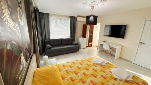 a living room with a bed and a couch at Hedi Sozopol in Sozopol