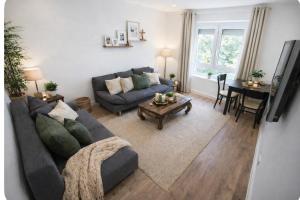 a living room with a couch and a table at Apartment Heide in Soltau