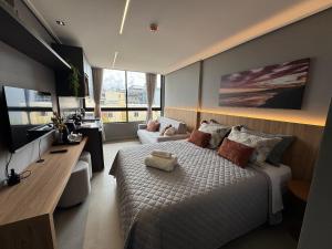 a bedroom with a large bed and a television at Acqua Tambaú Luxury Flat 100 meters from the sea in João Pessoa +222 photos