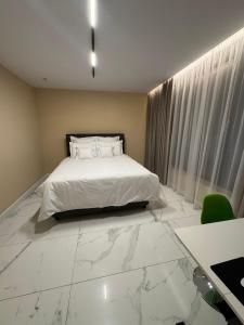 a bedroom with a bed with a marble floor at KNIGHT Villa in Voluntari