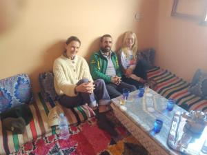 a group of three people sitting on a couch at Sidi hssain in Amizmiz