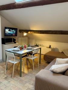 a living room with a table and chairs in a room at Appartamento centro parma con ascensore BORGO 22 in Parma