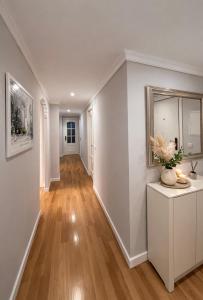 a hallway of a home with white walls and wood floors at Luxury Double Room Marbella Center in Marbella