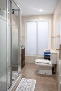 a bathroom with a toilet and a glass shower at Luxury Double Room Marbella Center in Marbella