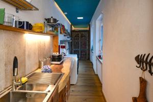a kitchen with a sink and a counter at Pension Pulvermühle in Waischenfeld