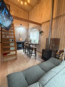 a living room with a table and a stove at Tiny House A & M Chaiten in Chaitén