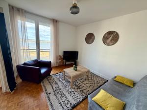 a living room with a couch and a table at Apartment with exceptional views in Saint-Nazaire
