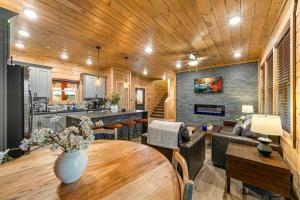 a living room with a wooden ceiling and a table at Indoor Pool Hot Tub, Pets Welcome, Arcade Games - Sleeps 14 in Pigeon Forge