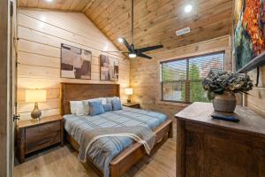 a bedroom with a bed in a wooden cabin at Indoor Pool Hot Tub, Pets Welcome, Arcade Games - Sleeps 14 in Pigeon Forge