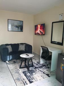 a living room with a couch and a table at AA Suites 87 in Nairobi
