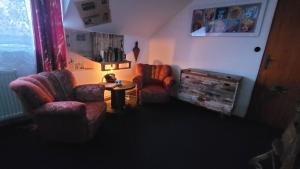 a living room with two chairs and a table at Southfork Farma Všetice in Benešov