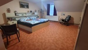 a bedroom with a bed and a table and a chair at Southfork Farma Všetice in Benešov +12 photos