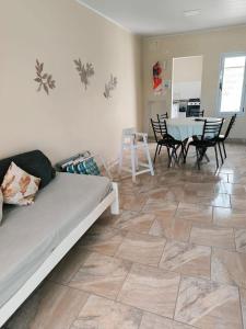 a living room with a couch and a table and chairs at Bungalows Casa Mansa 1 y 2 in Villa Elisa
