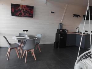 a room with a table and chairs and a kitchen at A Frame HAPPINESS in Yasinya