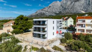 an image of a building with a mountain in the background at Sunshine Breeze in Promajna