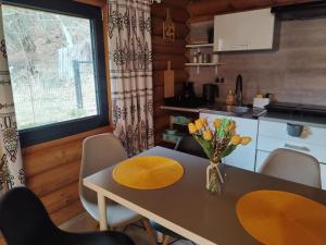 a kitchen and dining room with a table and chairs at Chatka pod lasem Szczyrk Domek z jacuzzi in Szczyrk +5 photos
