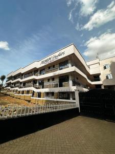a building with a fence in front of it at AA Suites 87 in Nairobi