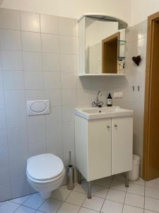 a white bathroom with a toilet and a sink at Giebelblick Barweiler in Barweiler +26 photos