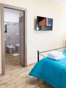 a bedroom with a blue bed and a bathroom at Casale Saporito in Montopoli in Sabina +61 photos