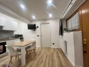 a kitchen with a table and chairs and a refrigerator at La Nicchia in Pieve di Cadore +7 photos