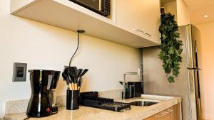a kitchen with a counter top with a sink at Moov Smart Home – Studios e Apartamentos por Temporada em Cuiabá in Cuiabá +286 photos