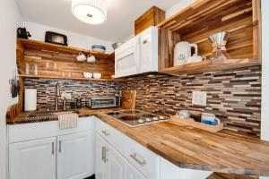 a kitchen with white cabinets and a wooden counter top at 1- Lookout Mountain Cottage in Lookout Mountain
