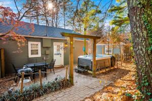 a backyard with a grill and a house at 1- Lookout Mountain Cottage in Lookout Mountain