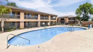a large swimming pool in front of a building at Tolleson Studio Pool & Gym Access for 2 in Tolleson